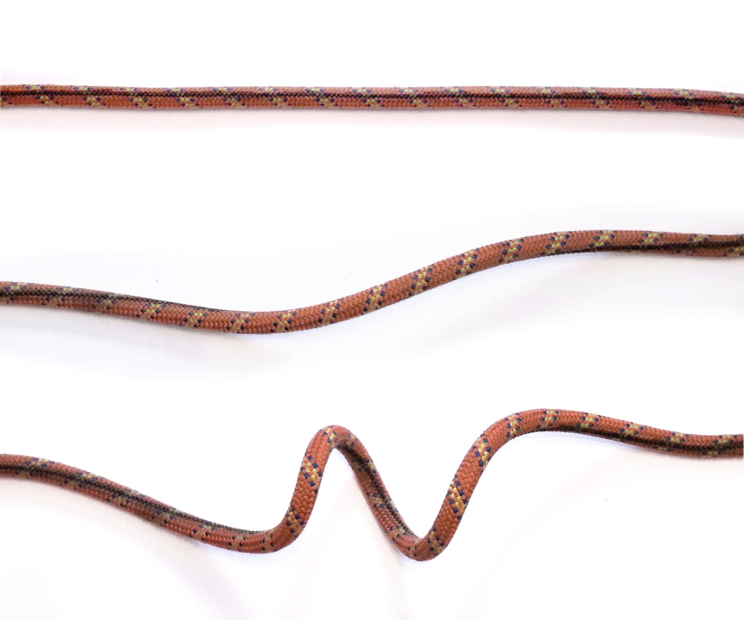 Three photos of the same orange braided rope on a white background: straight with no twist, in a gentle
              S-shaped curve with one twist, and buckled into a pronounced wave with two twists.